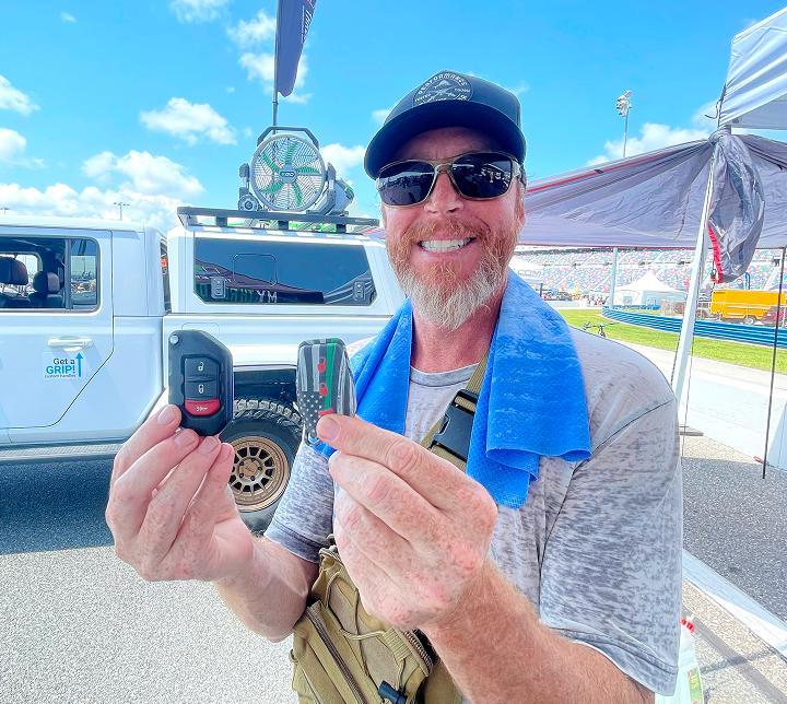 A person displaying custom Threedom fobs